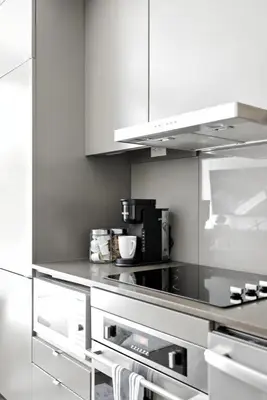a kitchen with white cabinets and a counter top at Trendy 1BR in TO Steps to Entertainment & Dining in Toronto