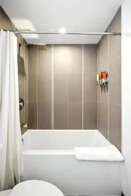 a bathroom with a tub and a shower curtain at Trendy 1BR in TO Steps to Entertainment & Dining in Toronto