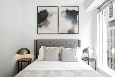a bedroom with a white bed with two lamps at Trendy 1BR in TO Steps to Entertainment & Dining in Toronto