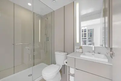 a bathroom with a toilet and a shower and a sink at Prime 2BR Condo with Massive Patio & Parking in Toronto