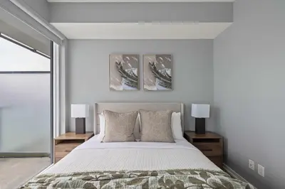 a bedroom with a large bed and two lamps at Chic 1-Bedroom Downtown Toronto Getaway in Toronto