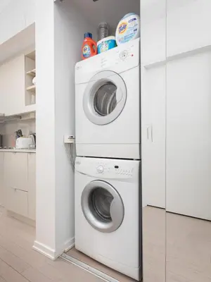 a white laundry room with a washer and dryer at Chic 1BR King Suite TOs Entertainment District in Toronto