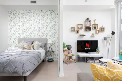 a bedroom with a bed and a tv in it at Chic 1BR King Suite TOs Entertainment District in Toronto