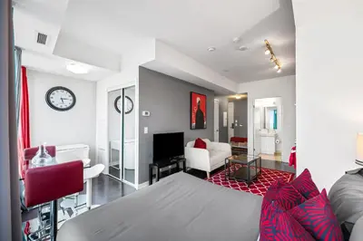 a room with a bed and a living room at Fort York Studio a Cozy Retreat in Downtown in Toronto