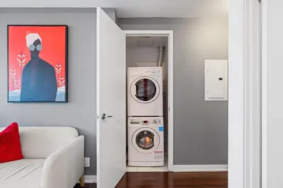 a washer and dryer in a living room with at Fort York Studio a Cozy Retreat in Downtown in Toronto