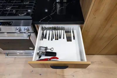 a kitchen with a white counter with utensils at Modern Parkdale Getaway 1-Bedroom Parking in Toronto