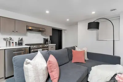 a living room with a gray couch with pillows at Modern 1-BR Condo with Parking in Downtown Toronto in Toronto