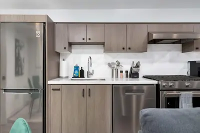 a kitchen with a sink and a stove at Modern 1-BR Condo with Parking in Downtown Toronto in Toronto