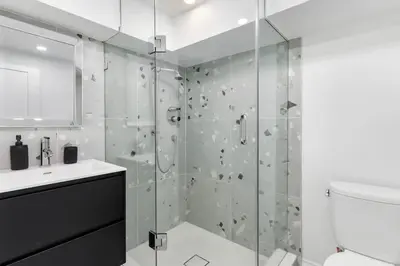 a bathroom with a shower and a toilet and a sink at Modern 1-BR Condo with Parking in Downtown Toronto in Toronto