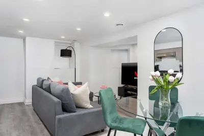 a living room with a couch and a glass table at Modern 1-BR Condo with Parking in Downtown Toronto in Toronto