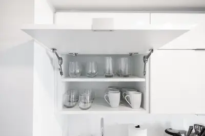 a kitchen shelf with glasses and cups on it at Modern Lakefront Esc Stylish 2BR Condo with Patio in Toronto
