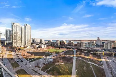 a view of a city with tall buildings at Modern Lakefront Esc Stylish 2BR Condo with Patio in Toronto