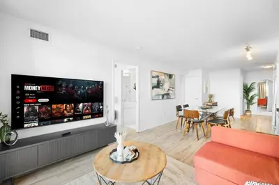 a living room with a large flat screen tv at Modern Lakefront Esc Stylish 2BR Condo with Patio in Toronto