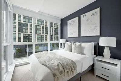 a bedroom with a large white bed and large windows at Gorgeous 2BR in Downtown Toronto w City Views in Toronto