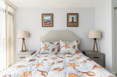 a bedroom with a bed with shells on it at Spacious 1 Bedroom plus Den Condo Iceboat Terrace Downtown Toronto in Toronto