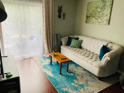 a living room with a couch and a table at Peterborough Cosy Apartment in Peterborough