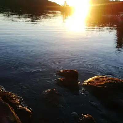 a view of a lake with rocks in the water at Olga's Bay Lake House in Minett