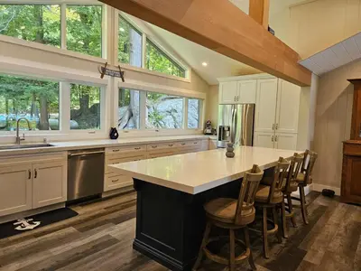 a kitchen with a large island with a counter top at Olga's Bay Lake House in Minett
