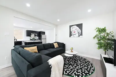 a living room with a couch and a table at The Hamilton Haven in Hamilton