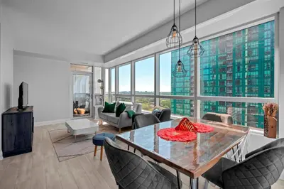 a living room with a table and chairs at Panoramic 2 Bedroom 2 Bathroom Condo Sheppard Metro North York Toronto in Toronto