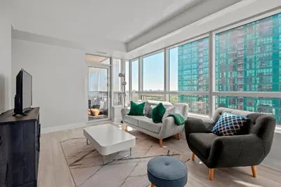 a living room with a view of a tall building at Panoramic 2 Bedroom 2 Bathroom Condo Sheppard Metro North York Toronto in Toronto