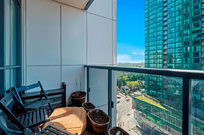 a balcony with a table and chairs on a building at Panoramic 2 Bedroom 2 Bathroom Condo Sheppard Metro North York Toronto in Toronto