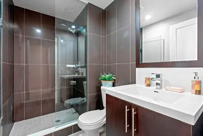 a bathroom with a toilet and a sink and a shower at Panoramic 2 Bedroom 2 Bathroom Condo Sheppard Metro North York Toronto in Toronto