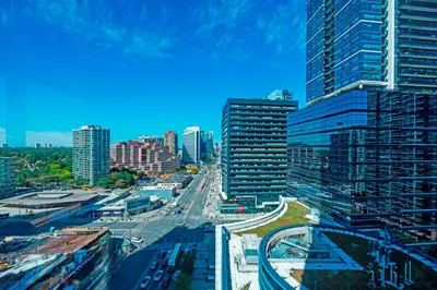 a view of a city with tall buildings and a highway at Panoramic 2 Bedroom 2 Bathroom Condo Sheppard Metro North York Toronto in Toronto