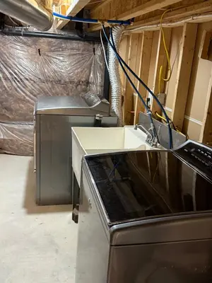 a kitchen with a stove and a sink at Comfy Basement Suite in Quiet Neighbourhood in Whitby