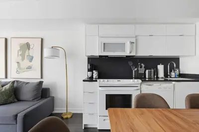a living room with a couch and a kitchen at Trendy 1BR Condo Free Parking Downtown Toronto in Toronto