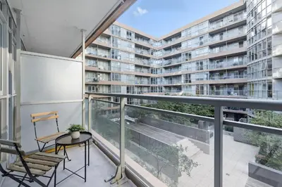 an apartment balcony with a chair and a table at Trendy 1BR Condo Free Parking Downtown Toronto in Toronto