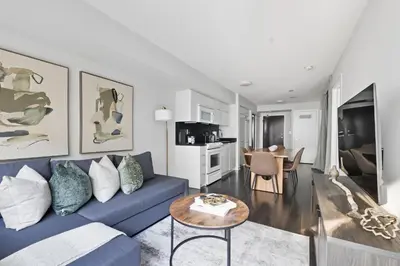 a living room with a blue couch and a table at Trendy 1BR Condo Free Parking Downtown Toronto in Toronto