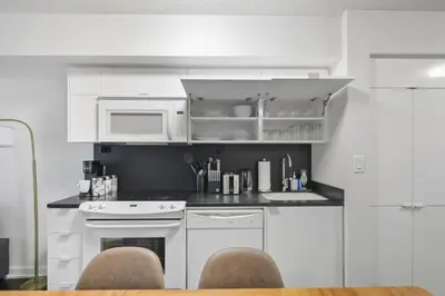 a kitchen with white appliances and a white microwave at Trendy 1BR Condo Free Parking Downtown Toronto in Toronto