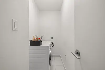 a bathroom with white walls and a white counter top at Stylish 1BR Condo with Patio Steps from Waterfront in Toronto