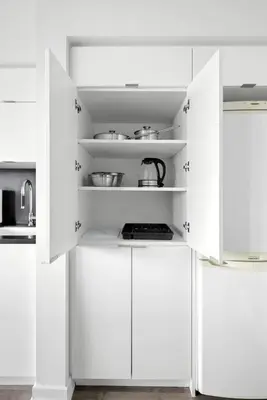 a white kitchen with white cabinets at Modern 2BR Condo Stunning Views Walk Everywhere in Toronto