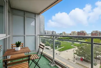 a balcony with a bench and a view of a city at Modern 2BR Condo Stunning Views Walk Everywhere in Toronto