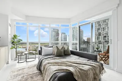 a bedroom with a bed and a large window at Family-Friendly Sleep 8 Steps to all Attractions in Toronto