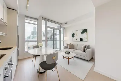 a living room with a table and a couch at Ritzdale Suites - Toronto's Entertainment District in Toronto