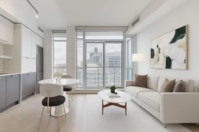 a living room with a couch and a table at Ritzdale Suites - Toronto's Entertainment District in Toronto