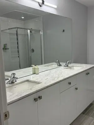 a bathroom with two sinks and a large mirror at masters bet room in Whitby