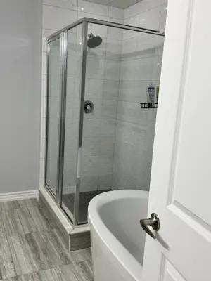 a bathroom with a shower and a bath tub at masters bet room in Whitby