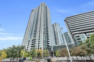 two tall buildings in a city with trees in front at Lakeview 1-Bedroom Condo-Downtown Toronto-Free Parking in Toronto