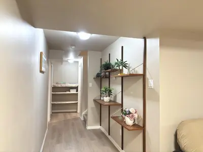 a hallway with shelves and plants in a room at Spacious 2-BR Basement Suite Near Lake Simcoe & Beach Park in Innisfil