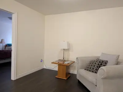 a living room with a couch and a table with a lamp at Modern 3BR Home Near Niagara Falls & Welland Canal in Welland