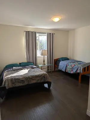 a bedroom with two beds and a window at Modern 3BR Home Near Niagara Falls & Welland Canal in Welland