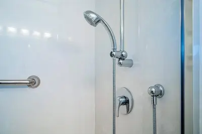 a shower with a glass door with a shower head at Bright, Modern & Cozy Getaway Home in the GTA in Whitby