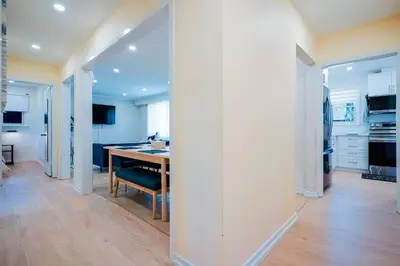 a kitchen and dining room with a wooden table at Bright, Modern & Cozy Getaway Home in the GTA in Whitby