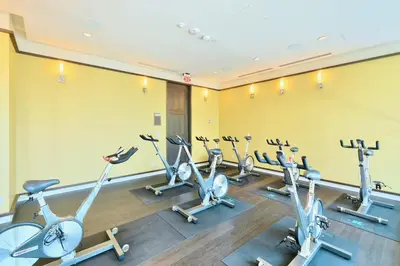 a row of exercise bikes in a gym at Luxury 1BR Suite w Skyline City Views - The Roland in Toronto