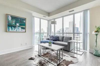 a living room with a couch and a table at Luxury 1BR Suite w Skyline City Views - The Roland in Toronto