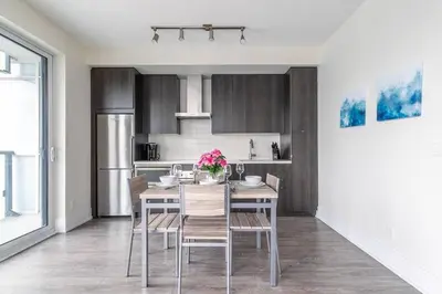 a kitchen with a table and chairs in a room at Luxury 1BR Suite w Skyline City Views - The Roland in Toronto